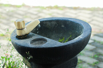 Hand washing area made of natural stone, running water tap, sink in public park made of natural...