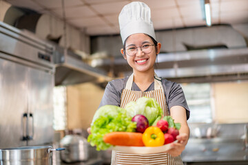 Smiling Young Chef Presenting Fresh Vegetables in Kitchen