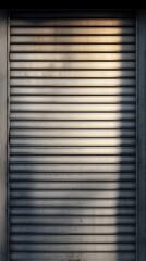 Closed metal shutter with shadows and light
