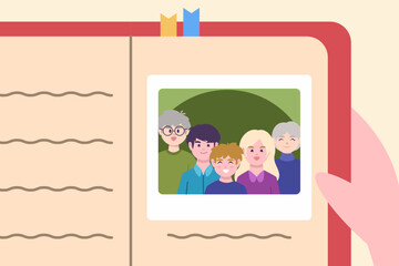A hand holding a memory book featuring a family photo with happy faces captured in a special moment.