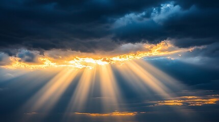 Golden sun rays burst through dramatic dark clouds