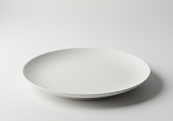 A simple white plate sits on a white background with soft shadows and clean minimalistic style
