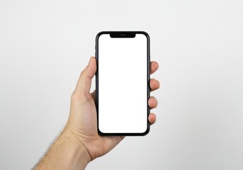 A hand holding a black smartphone with a blank white screen against a white background in a studio