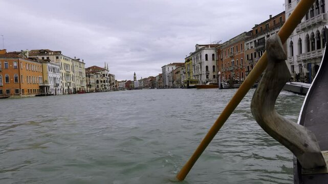Gondolier rowing gondola on grand canal in venice, Italy. Action