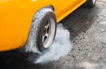 Drag racing car burns rubber off its tires in preparation for the race
