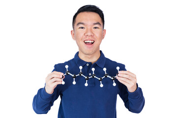 A young man in a blue long-sleeve polo shirt holds up a chemistry molecular model with a curious...