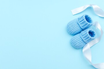 pair of blue baby booties on a blue background