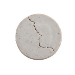 A cracked, circular object resembling a stone or concrete disc with a rough texture and subtle gray tones.