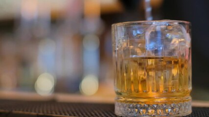 Enjoy a unique cocktail in a stylish glass with ice, perfect for social gatherings