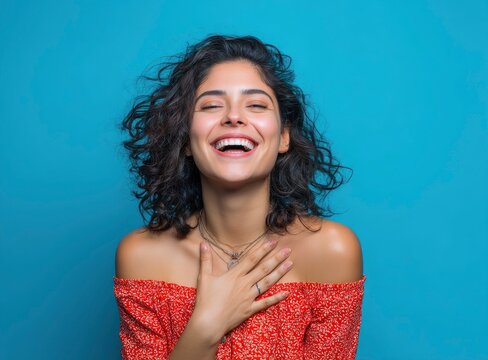 Joyful Woman with Curly Hair in Red Off-Shoulder Dress, Vibrant Portrait