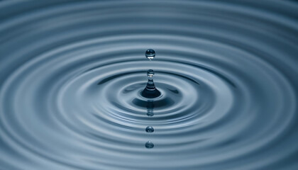 drop of water falling into a pool of water