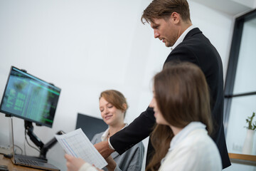 Fototapeta premium Business meeting in modern office with colleagues discussing projects and analyzing reports in bright environment
