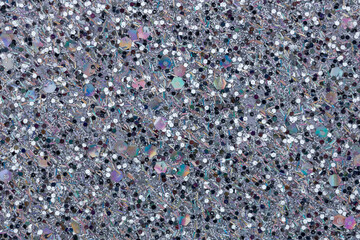 Full frame macro abstract texture background of sparkling silvery black glitter surface with copy space
