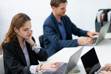 Business professionals collaborating in a modern office setting during work hours focusing on their...