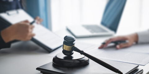 Lawyer with lawsuit meeting with client discussing with contract agreement at courtroom