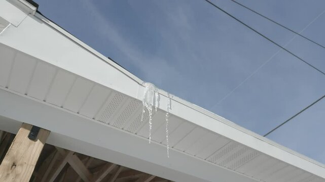 icicles hanging off a roof of a house