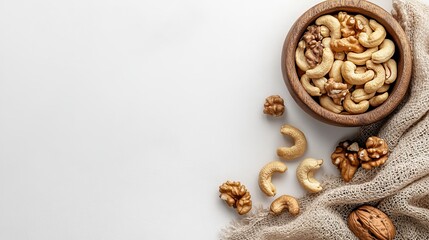 Fototapeta premium Delicious cashews and walnuts in wooden bowl on white background healthy snack food photography top