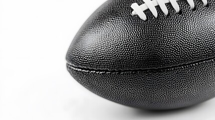 Obraz premium Classic black-white football photographed in close-up against pure white background, emphasizing clean shape, detailed texture, and high contrast for modern studio-based sport concepts