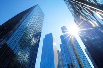 Fototapeta premium Modern skyscrapers under blue sky with sunlight through glass, symbolizing business success and real estate growth