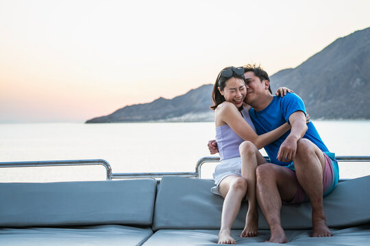 couple looking at camera on board of a yacht in the Red Sea