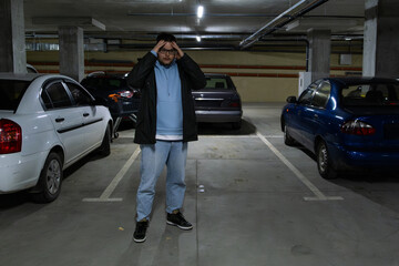 Fototapeta premium Person in Underground Parking Garage Figure Out of Stolen Car