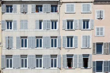 typical facade of an old hotel with open and closed shutters