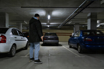 Person in Underground Parking Garage Figure Out of Stolen Car