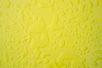 Raindrops on bright yellow table
