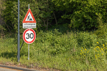 A road sign warns of road work ahead "uitvoegend werkverkeer" with a 30 km/h speed limit. Utrecht, the Netherlands. 12 April 2025.