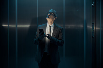 Worried businessman stuck in the lift
