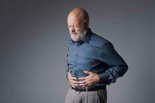 Senior man suffering from abdominal pain