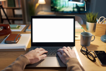 Man working on a laptop with blank screen