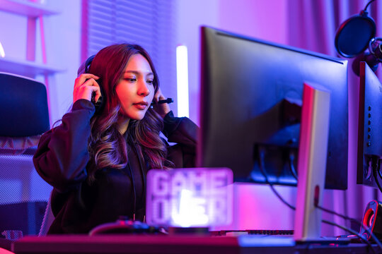 Asian beautiful esport woman gamer play online video game on computer. 
