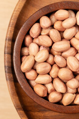 Raw Peanut in wooden bowl. Top view