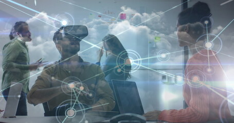 Image of network of connections over diverse business people with vr headset