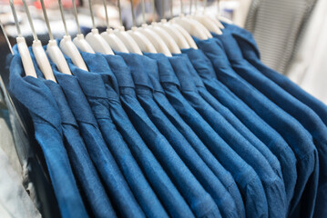 blue jeans like shirts on hangers