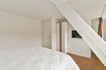 A clean and elegant bedroom featuring minimalist decor, warm wooden flooring, and subtle lighting, perfect for a serene retreat in contemporary living.