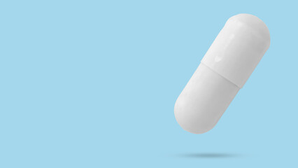 White medicine pill capsule float on blue background