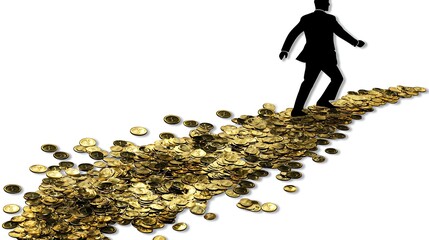 A path paved with gold coins. A businessman walks forward