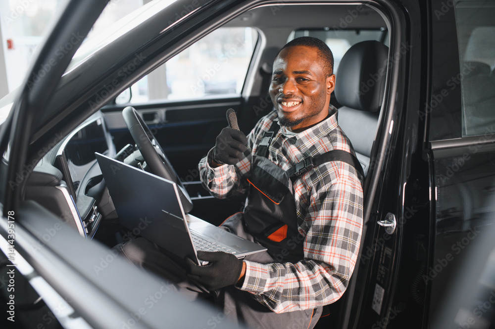 Aufkleber portrait of smiling mechanic in car service ordering new parts for damaged vehicle using tablet. afr