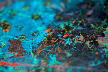 Thick abstract paint surface with heavy texture looking a bit like graffiti hand drawn real dark background