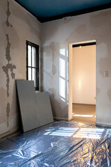 room undergoing interior renovation with sunlight illuminating the space