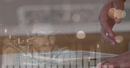 Image of statistics and financial data processing over businessman using tablet