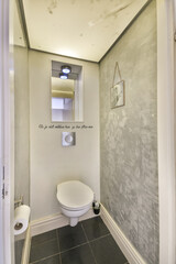 A stylish minimalist bathroom featuring a sleek toilet, modern wall finishes, and subtle lighting, perfect for contemporary interiors.