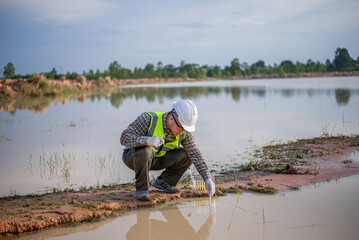 A biologist is examining aquatic life to check the health of the lake's ecosystem.