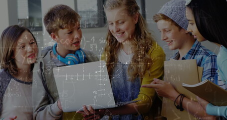 Image of mathematical equations over school children using laptop in classroom
