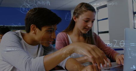 Image of mathematical equations over school children using laptop in classroom