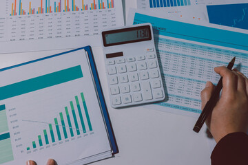 Tax deduction planning concept. Women use a calculator to calculate expenses and taxes to receive...