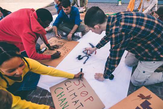 Young activists preparing posters for climate change protest