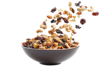 Colorful mix of dried fruits and nuts cascades into a rustic bowl against a clean background